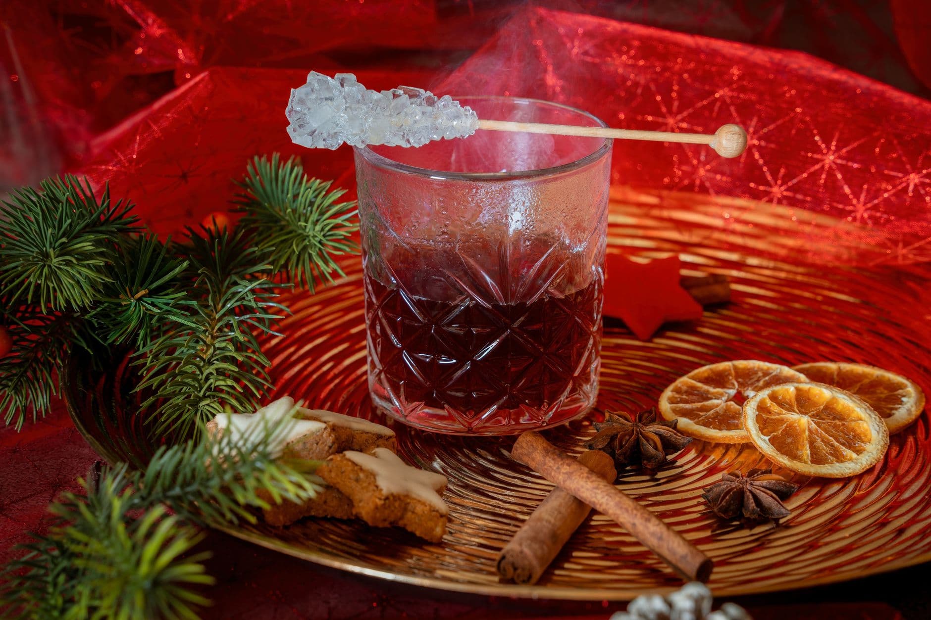A warm holiday drink with cinnamon, citrus, and festive cookies, perfect for Christmas celebrations.