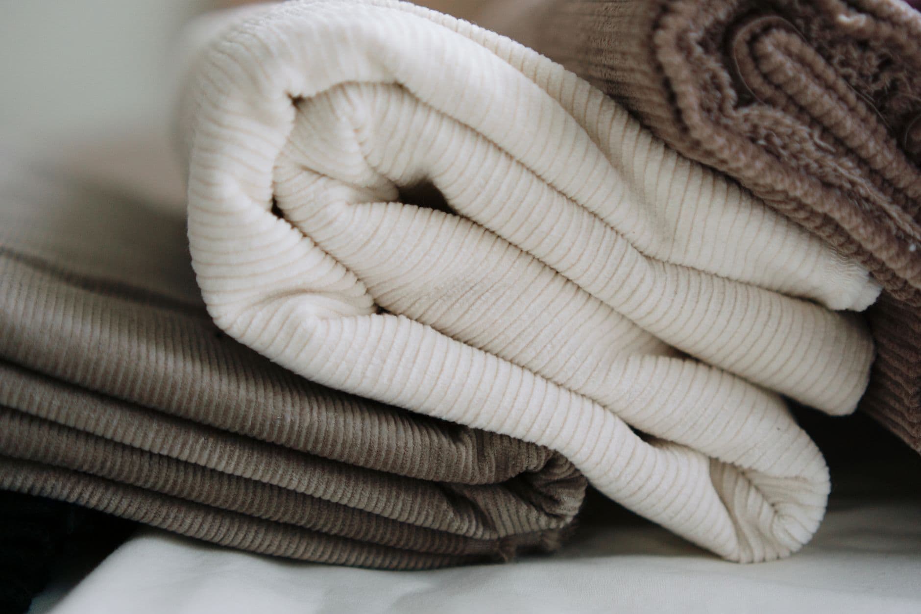 Folded cotton and corduroy in cream and taupe, stacked